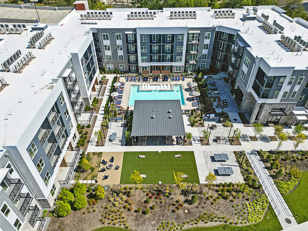 Drone overview of Station 316 Apartments and central couryard with pool.