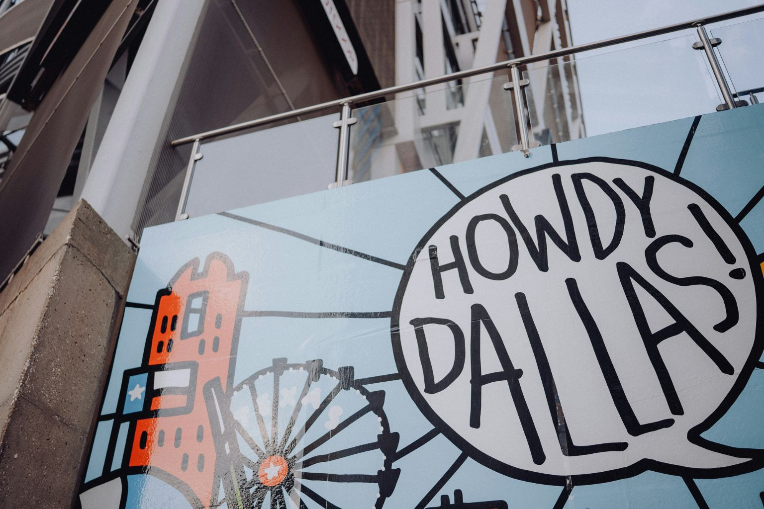 Dallas mural with city graphics and “Howdy Dallas!” text.