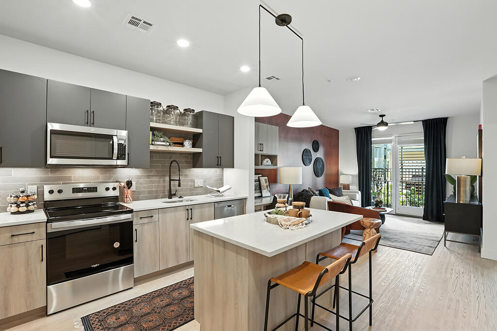 Charcoal design package kitchen including stainless steel appliances and dark upper cabinets